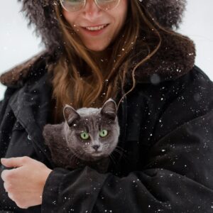 Woman Outdoors in Winter Holding a British Blue Cat